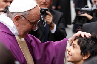 Pope Francis greets a boy after celebrating Mass at St. Anne's Parish within the Vatican. (CNS photo/Paul Haring)