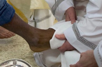 Pope Francis washes the foot of a prison inmate during the Holy Thursday Mass of the Lord's Supper. (CNS photo/L'Osservatore Romano via Reuters)