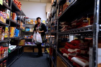 A woman gets groceries for a client at a Catholic-run food pantry in Rochester, N.Y. (CNS photo/Mike Curpi, Catholic Courier)