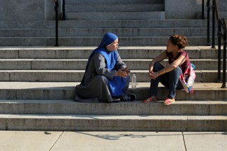 Sister Maria Asterone Dodeka chats with a woman outside St. Joseph Co-Cathedral in Brooklyn. (CNS photo/Gregory A. Shemitz)