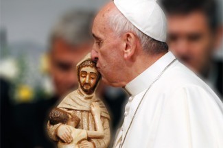 Pope Francis kisses a hand-carved figure of St. Francis given to him at a hospital in Rio de Janeiro. (CNS photo/Paul Haring)