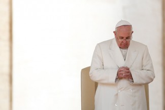 Pope Francis prays during his general audience in St. Peter's Square. (CNS photo/Tony Gentile, Reuters)