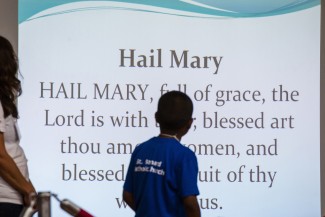 Vacation Bible School students take turns reciting the Hail Mary Aug. 1 at St. Bernard School in Green Bay, Wis. (CNS photo/Sam Lucero, The Compass) (Aug. 6, 2013)