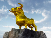 Golden calf standing on a rockface.