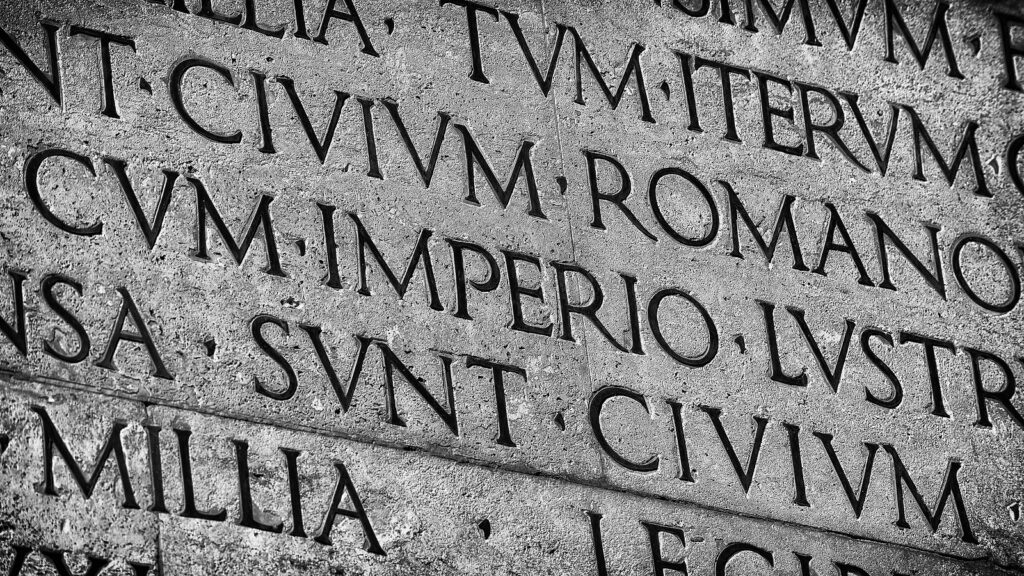 text in Latin from Augustus' Res Gestae. The words seen are Civium, Romano... Imperio... sunt...