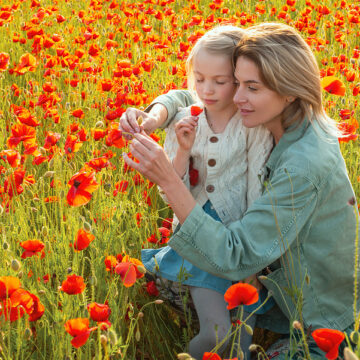 Mom and daughter picking flowers in a flower field