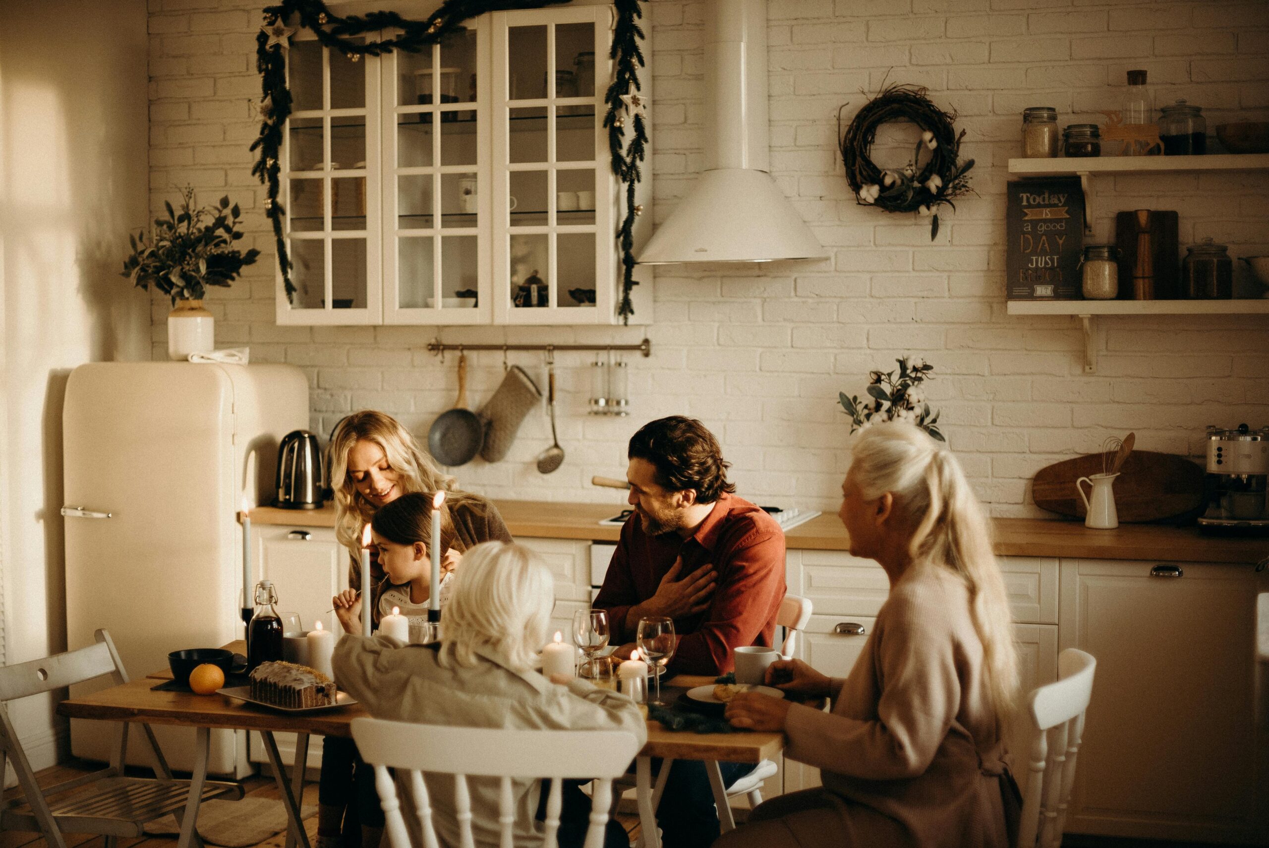 Family sitting at a table sharing a meal together.